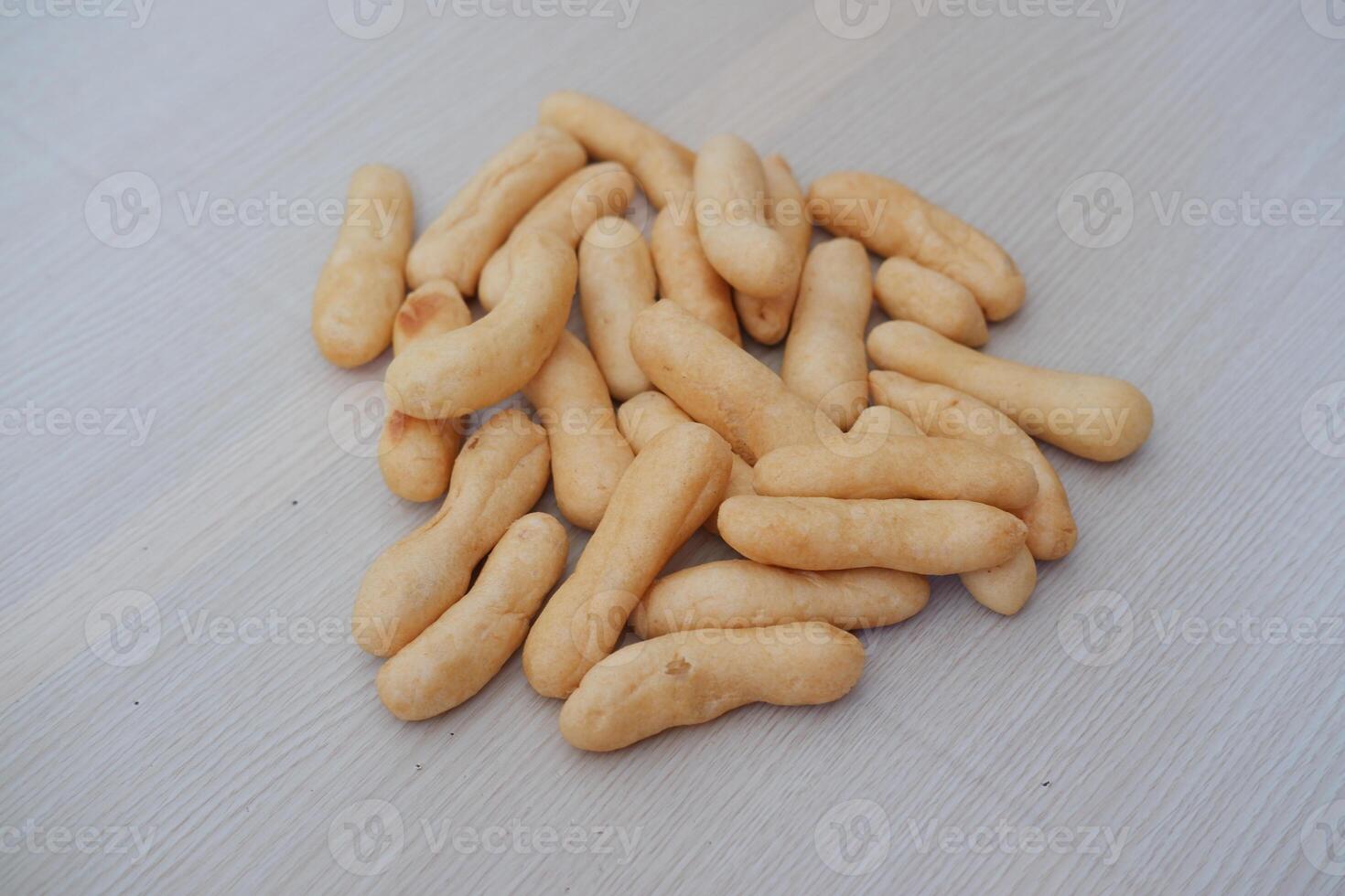 Close up of crunchy bread stick on wooden table background, stock photo