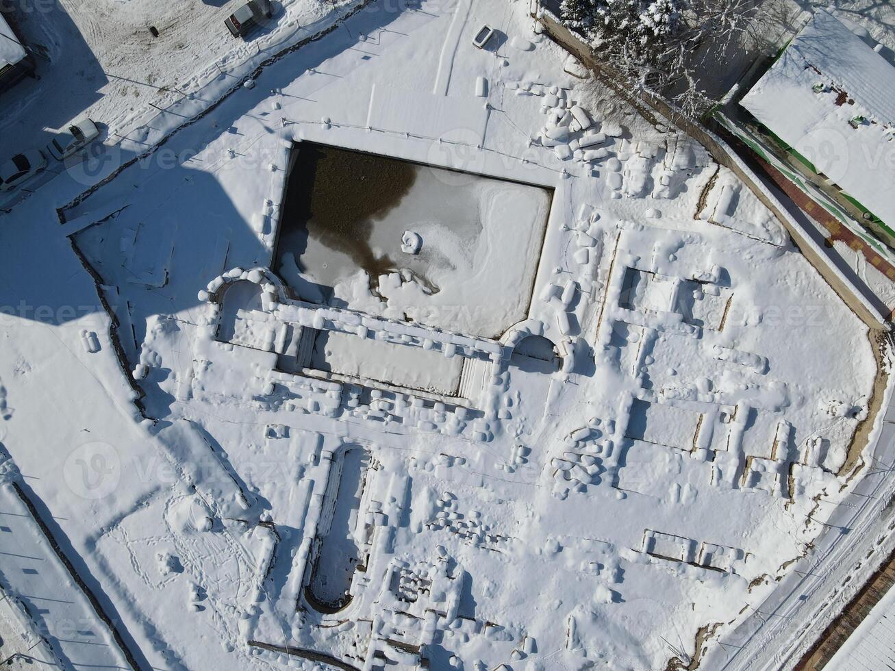 Basilica Therma is an ancient Roman spa town located in the Yozgat province of Turkey. Drone shooting on a snowy day photo