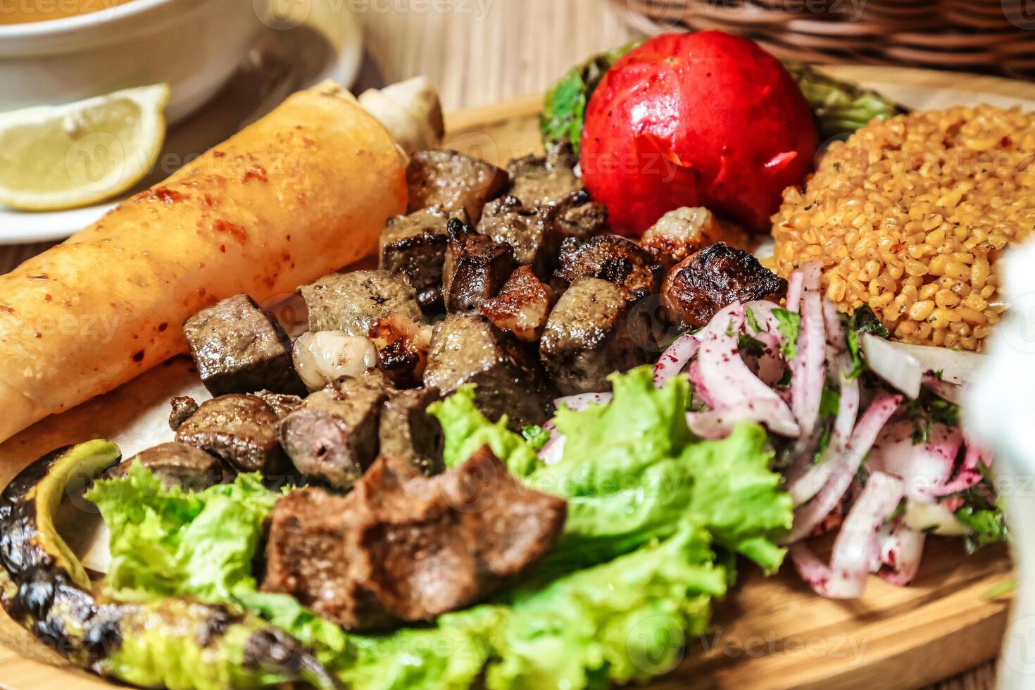 Plate of Food With Meat, Lettuce, and Tomato photo
