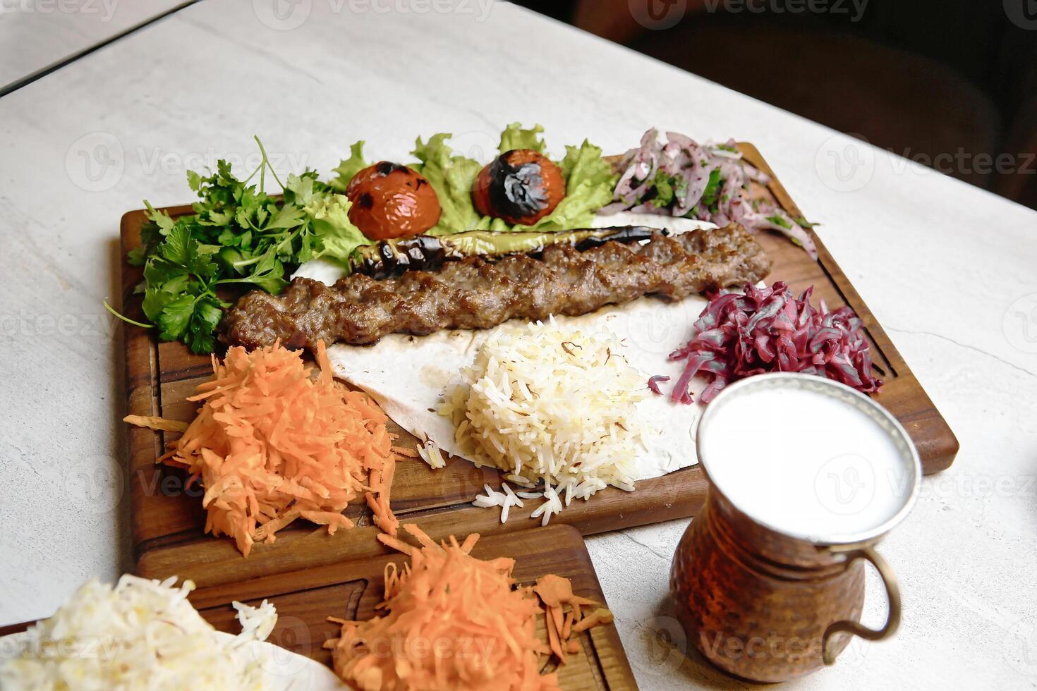 Wooden Cutting Board With Freshly Cut Meat and Vegetables photo