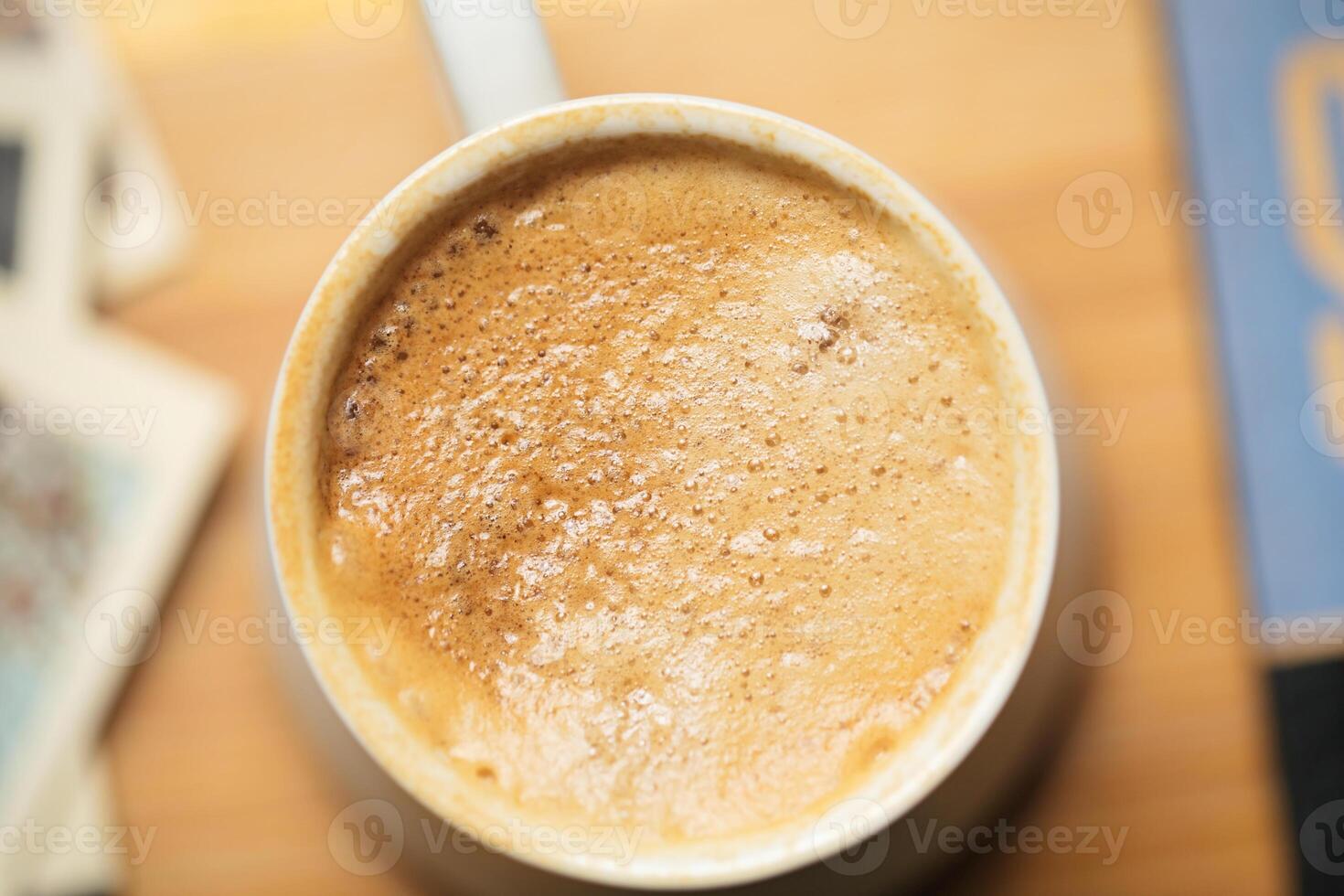 Cup of Coffee on Wooden Table photo