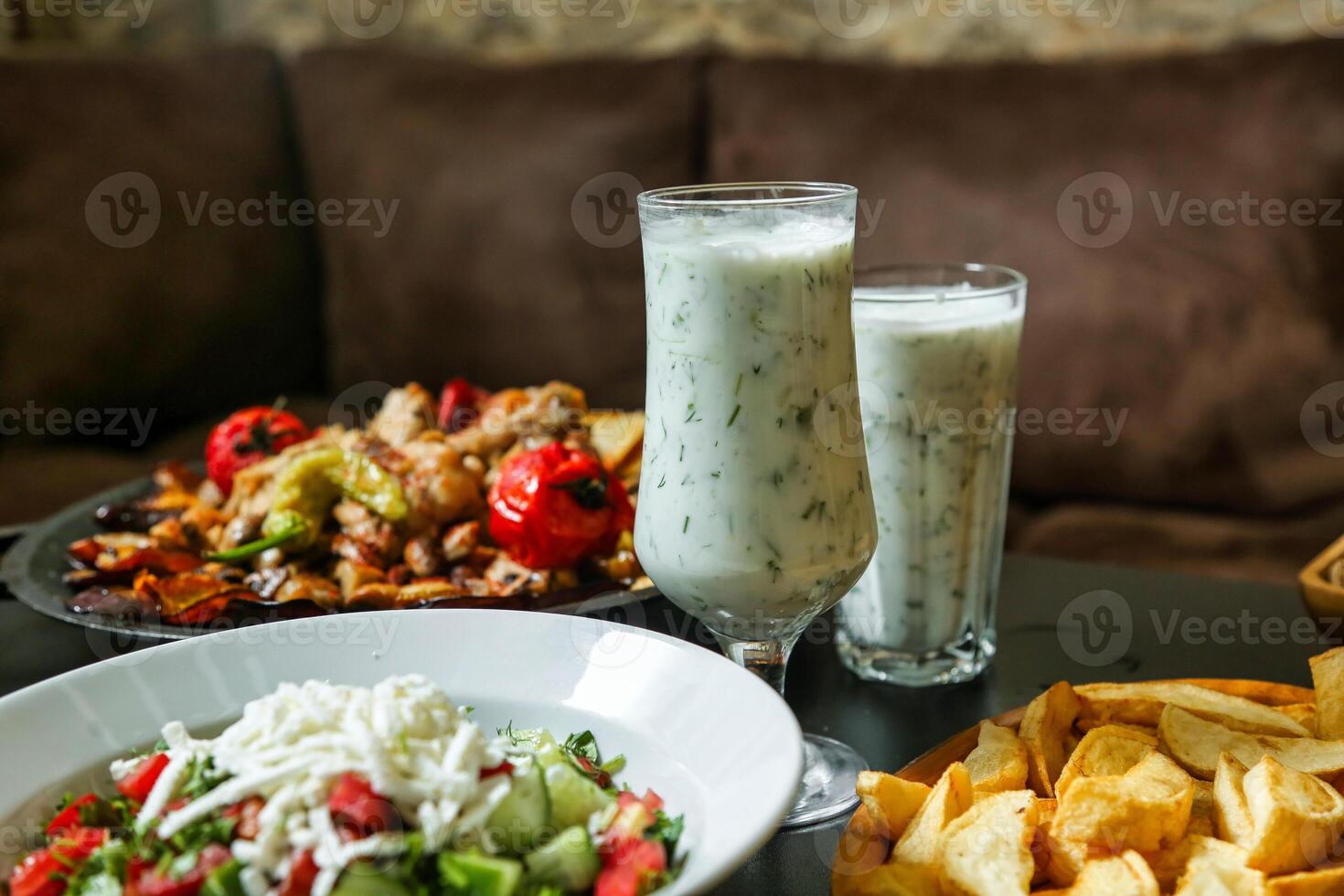 Table Displaying Assorted Plates of Food and Beverages photo