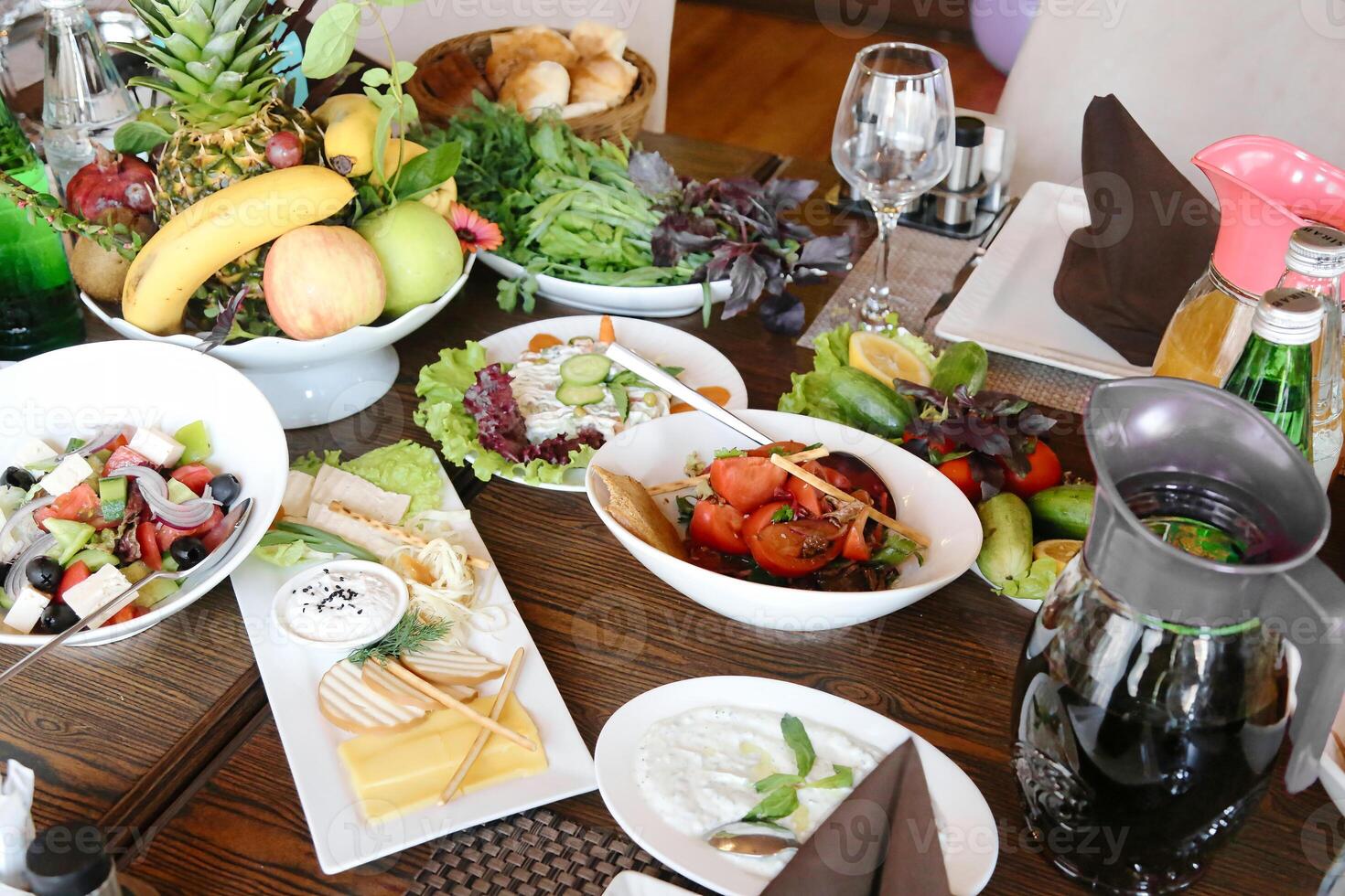 Wooden Table With Deliciously Plated Food photo