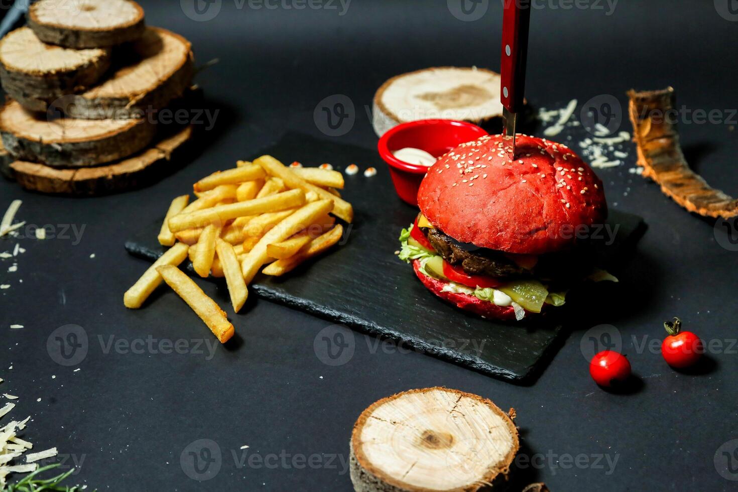 Appetizing Hamburger and French Fries on Cutting Board photo