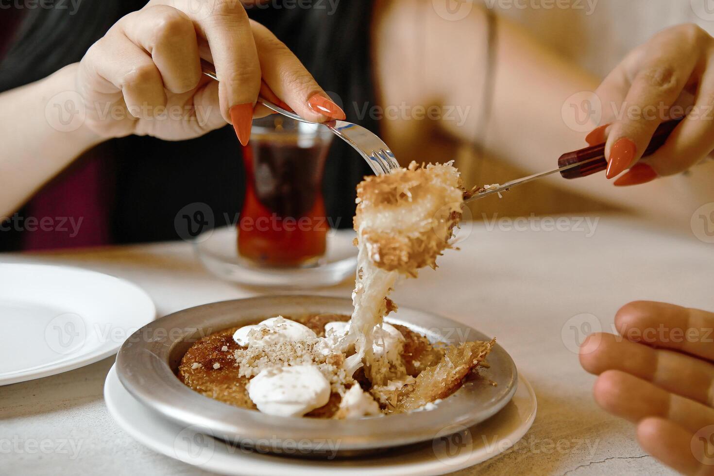 Woman Eating Plate of Food With Fork photo