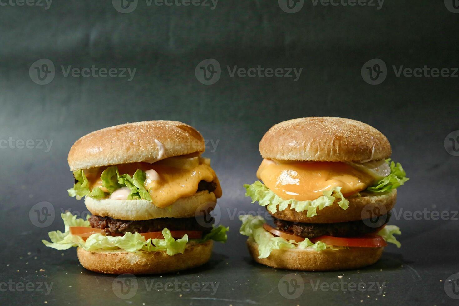 Two Hamburgers Placed on Table Surface photo