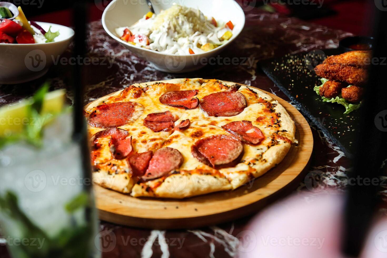 Pepperoni Pizza on Wooden Cutting Board photo