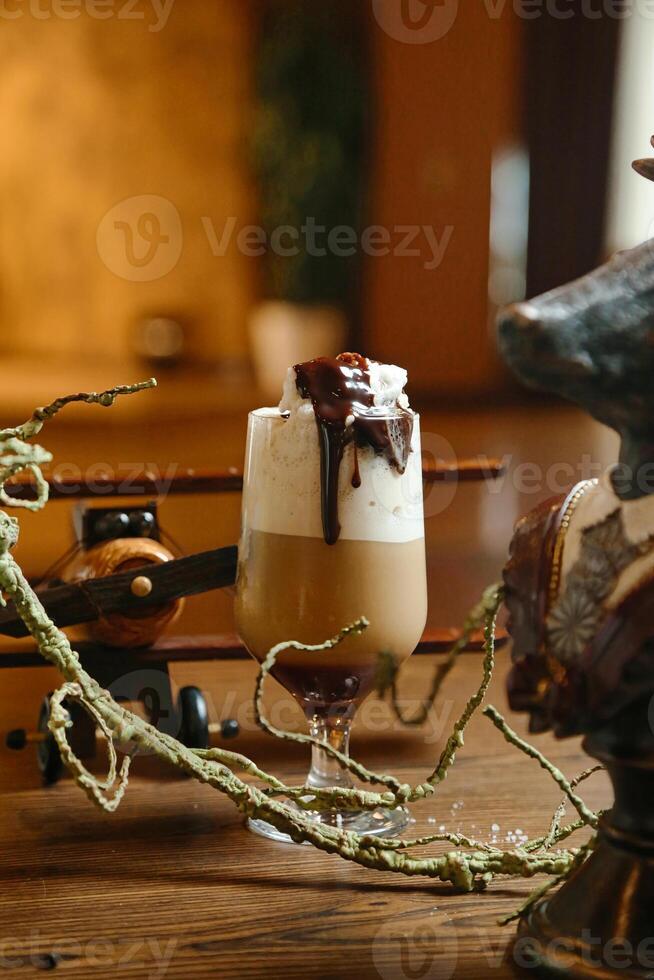Glass of Liquid on Wooden Table photo