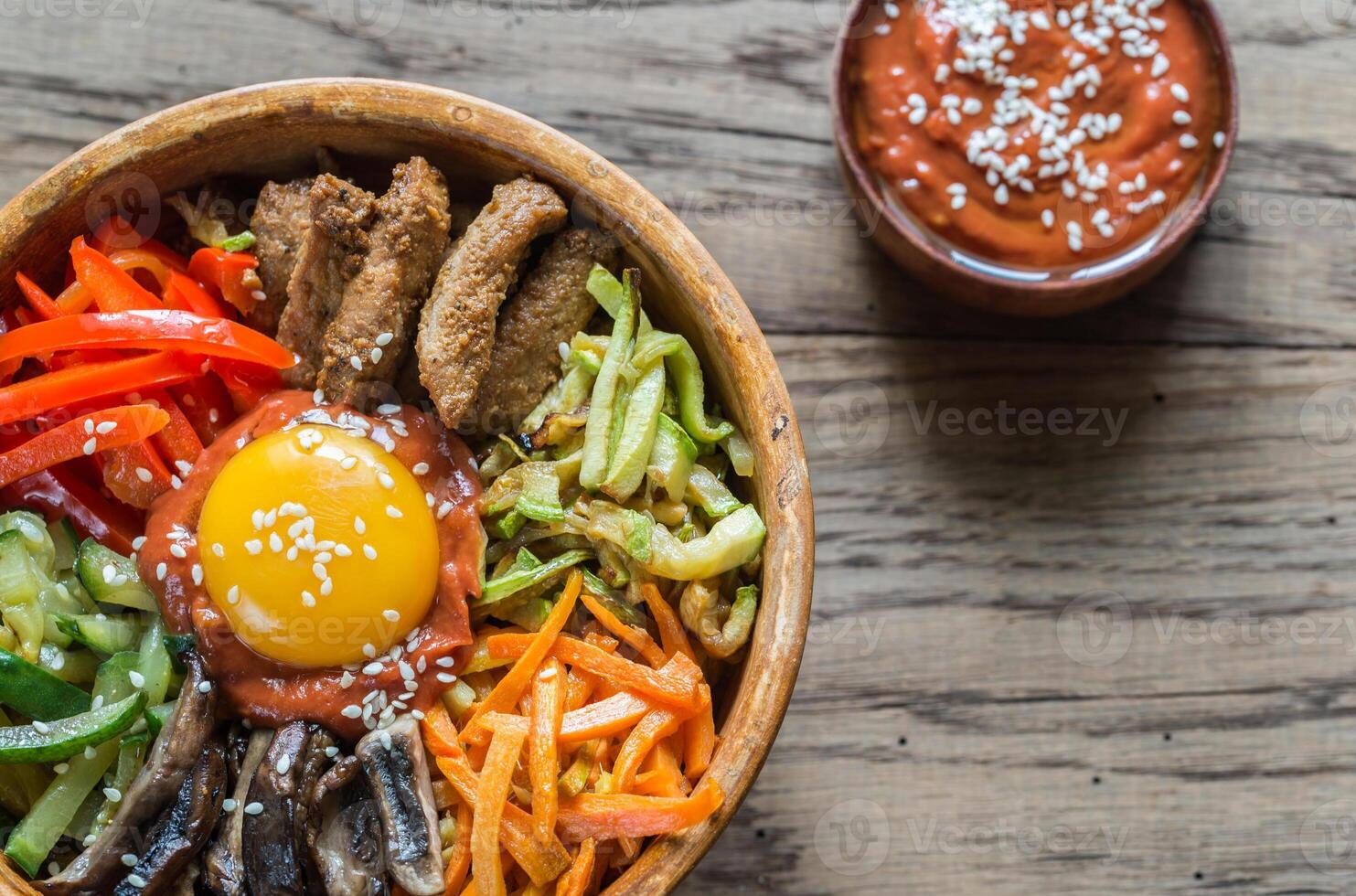 Bowl of bibimbap on the wooden table photo
