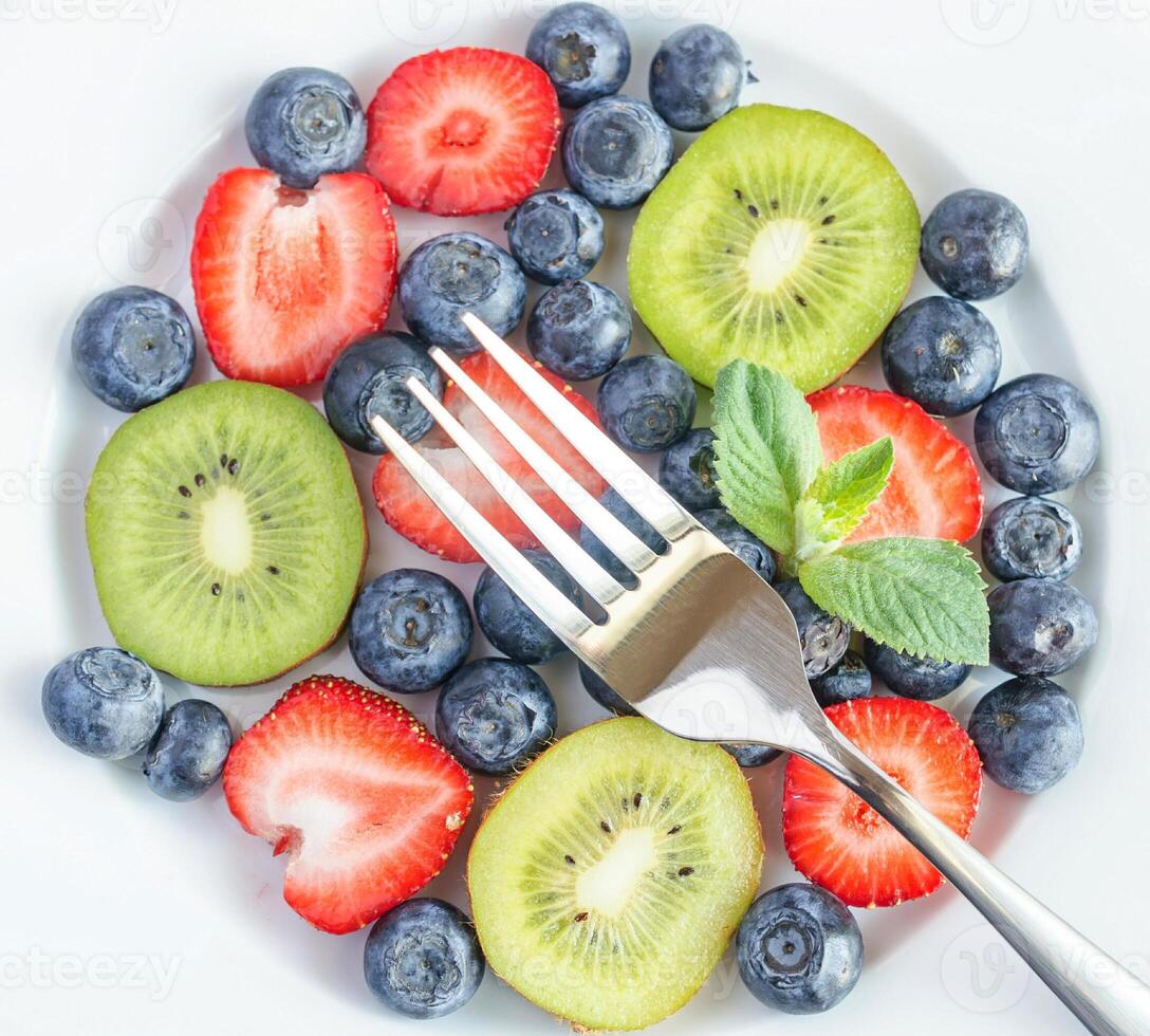 Mixed berries and kiwi fruit photo