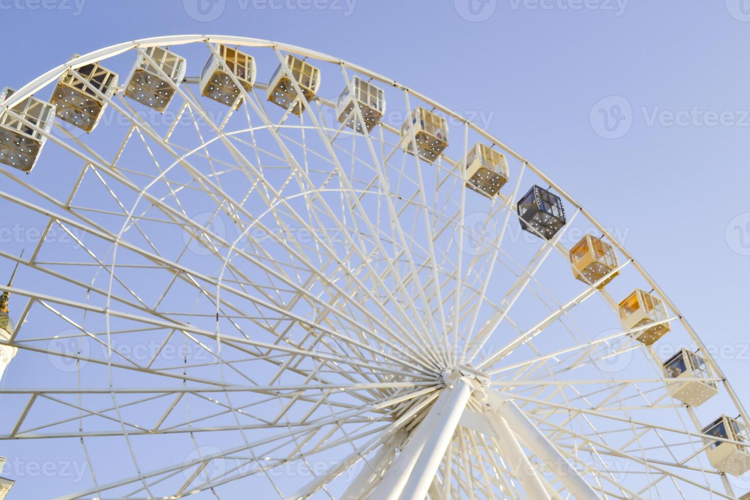 Ferris wheel against a blue sky background. photo