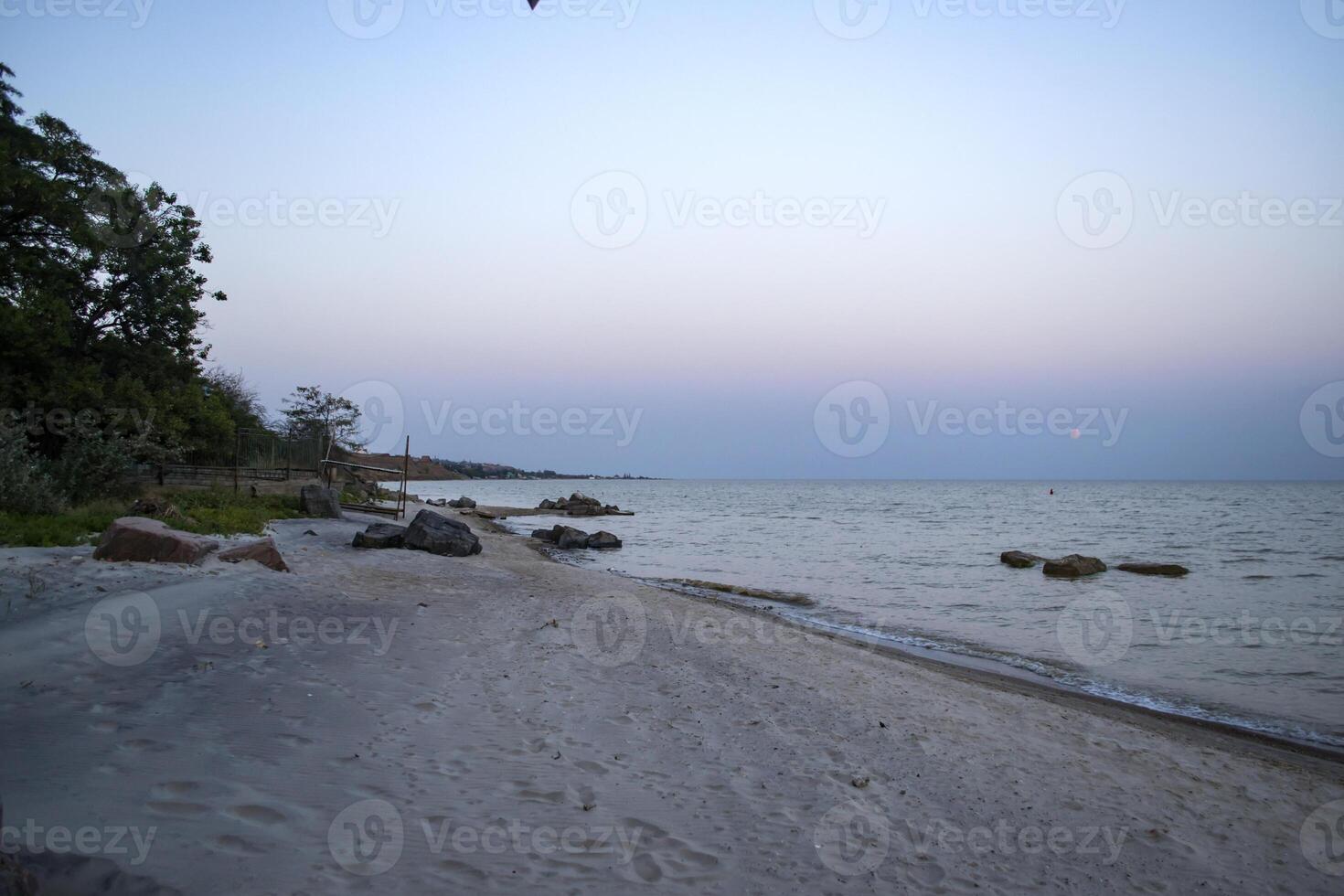 Beautiful sunset on the deserted beach. The place for rest and relaxation. photo