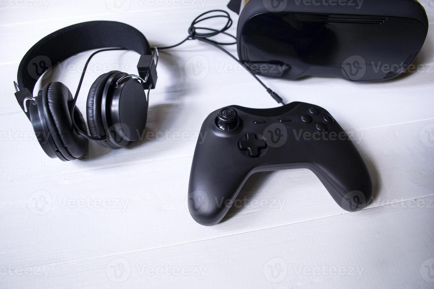 Virtual reality glasses, joystick and headphones on a white background. photo