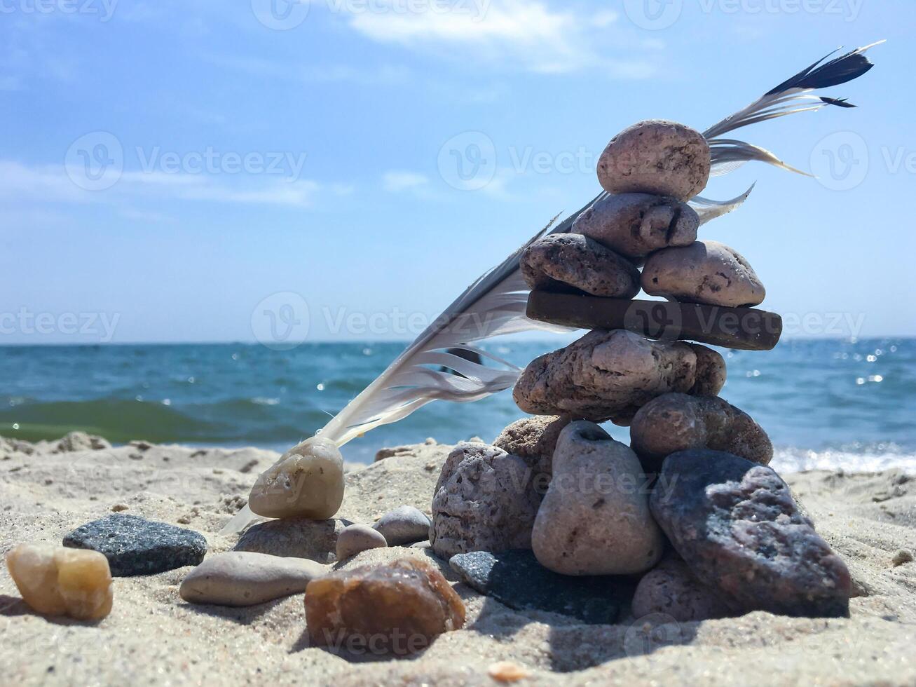 A group of sea stones on the sand near sea. photo