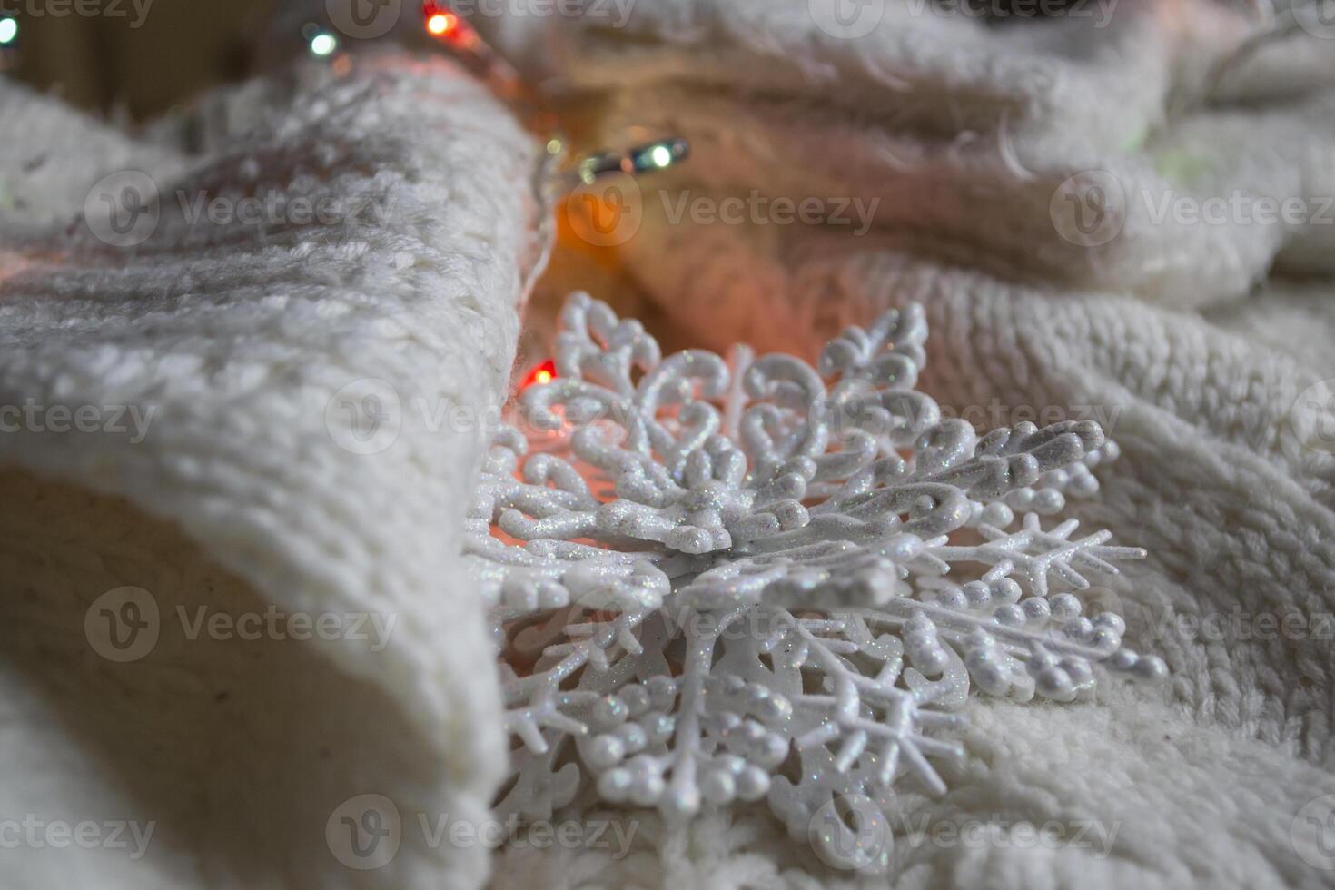 White knitted texture with decor. Soft clothes. Winter season. photo