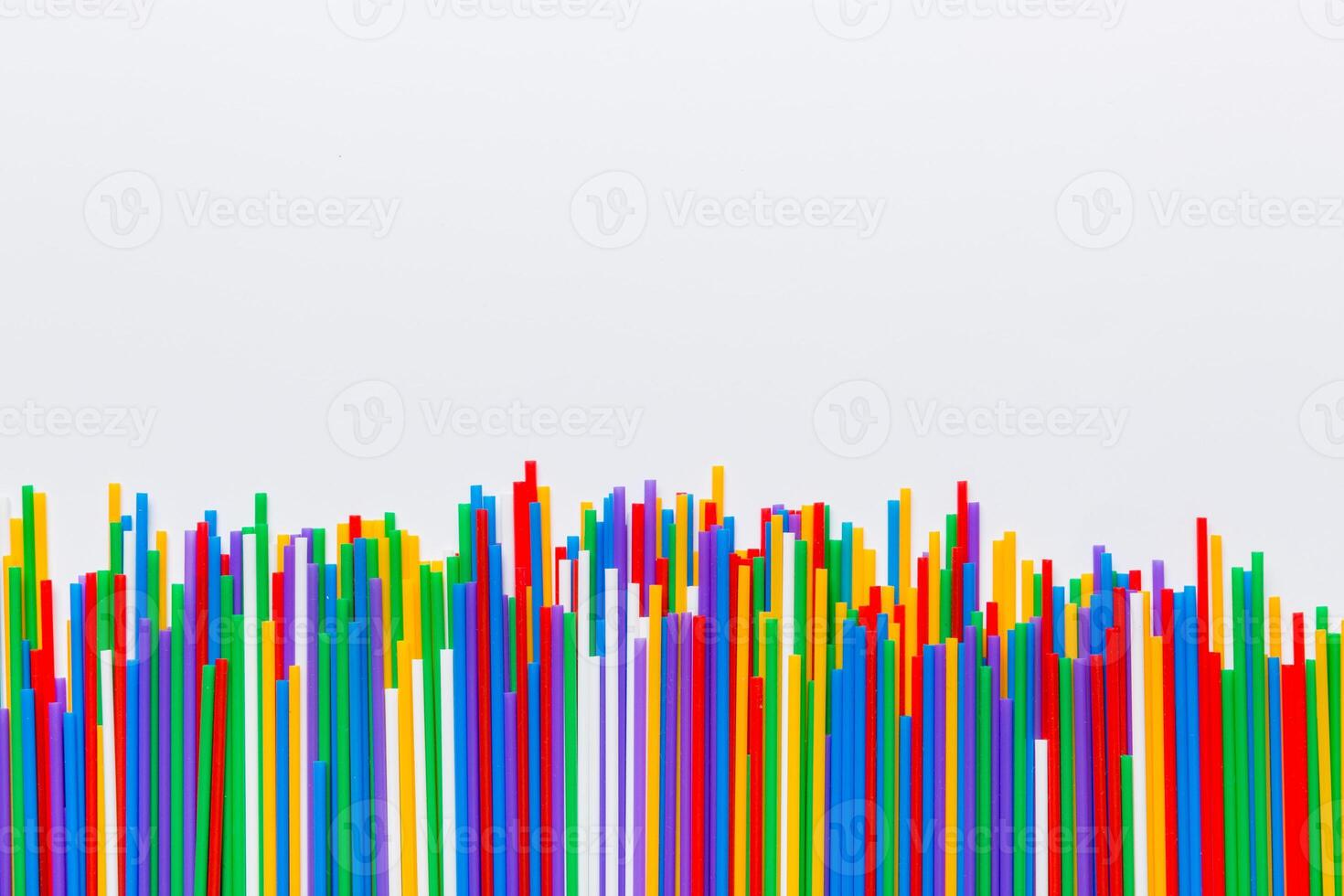 Heap of colorful plastic drinking straws on Colored background, flat lay. Copy Space for text photo