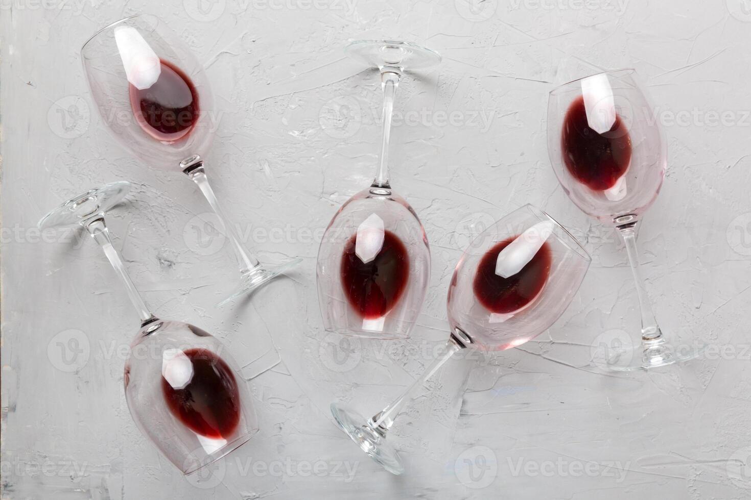 Many glasses of red wine at wine tasting. Concept of red wine on colored background. Top view, flat lay design photo