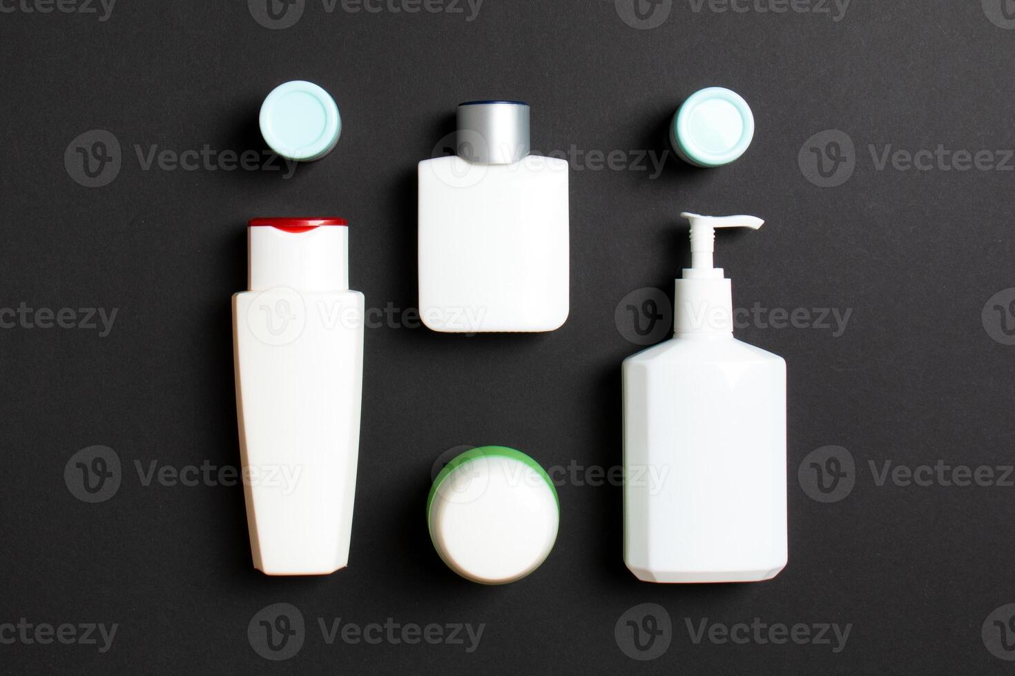 Cosmetics SPA branding mock-up, top view with copy space. set of tubes and jars of cream flat lay on colored background photo