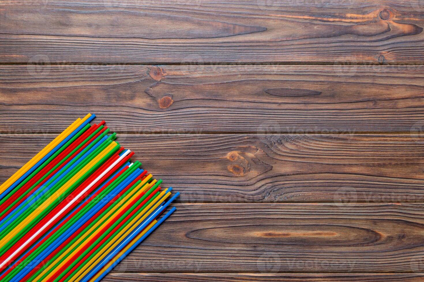 Heap of colorful plastic drinking straws on Colored background, flat lay. Copy Space for text photo