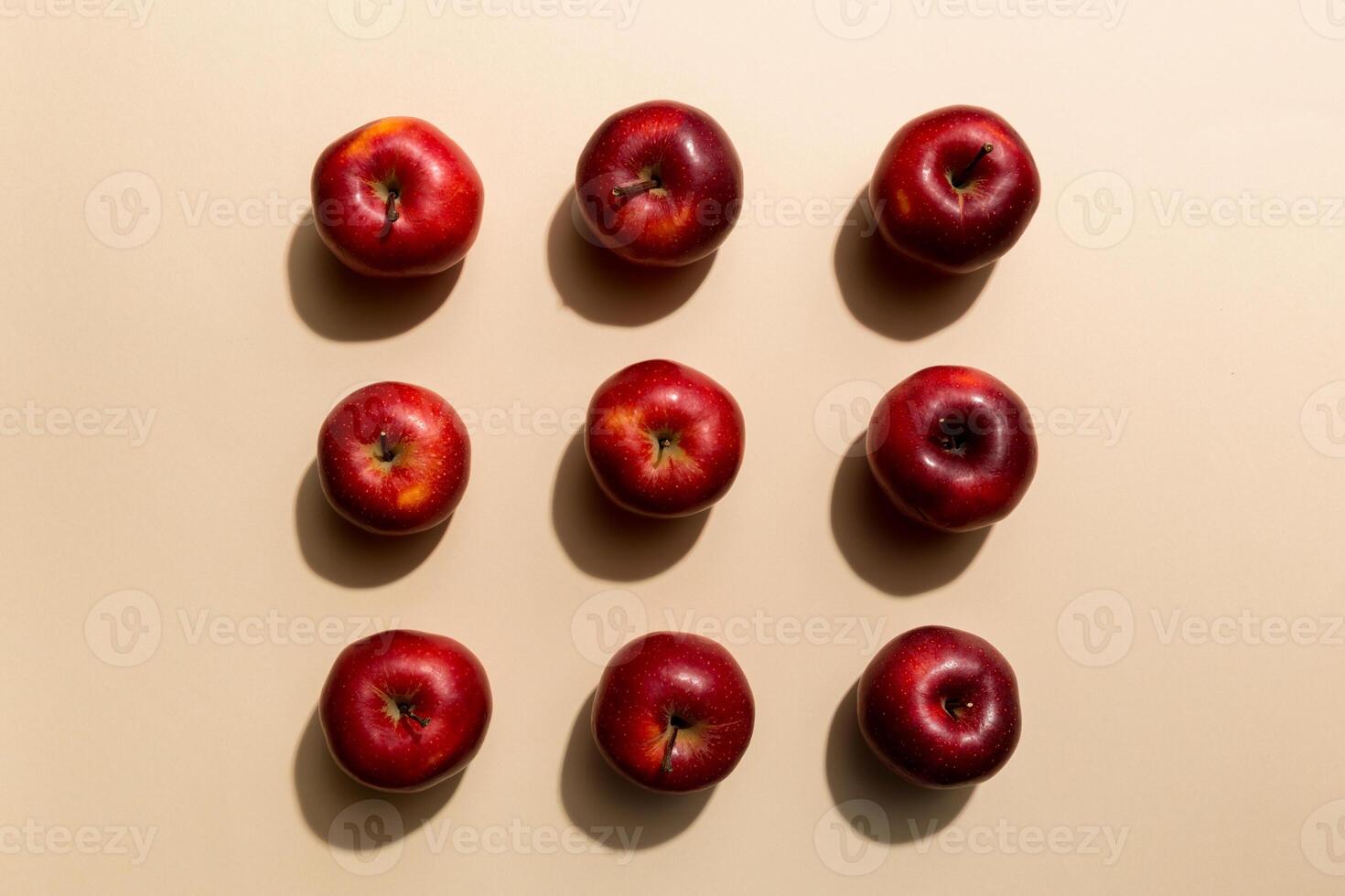 Many red apples on colored background, top view. Autumn pattern with fresh apple above view photo