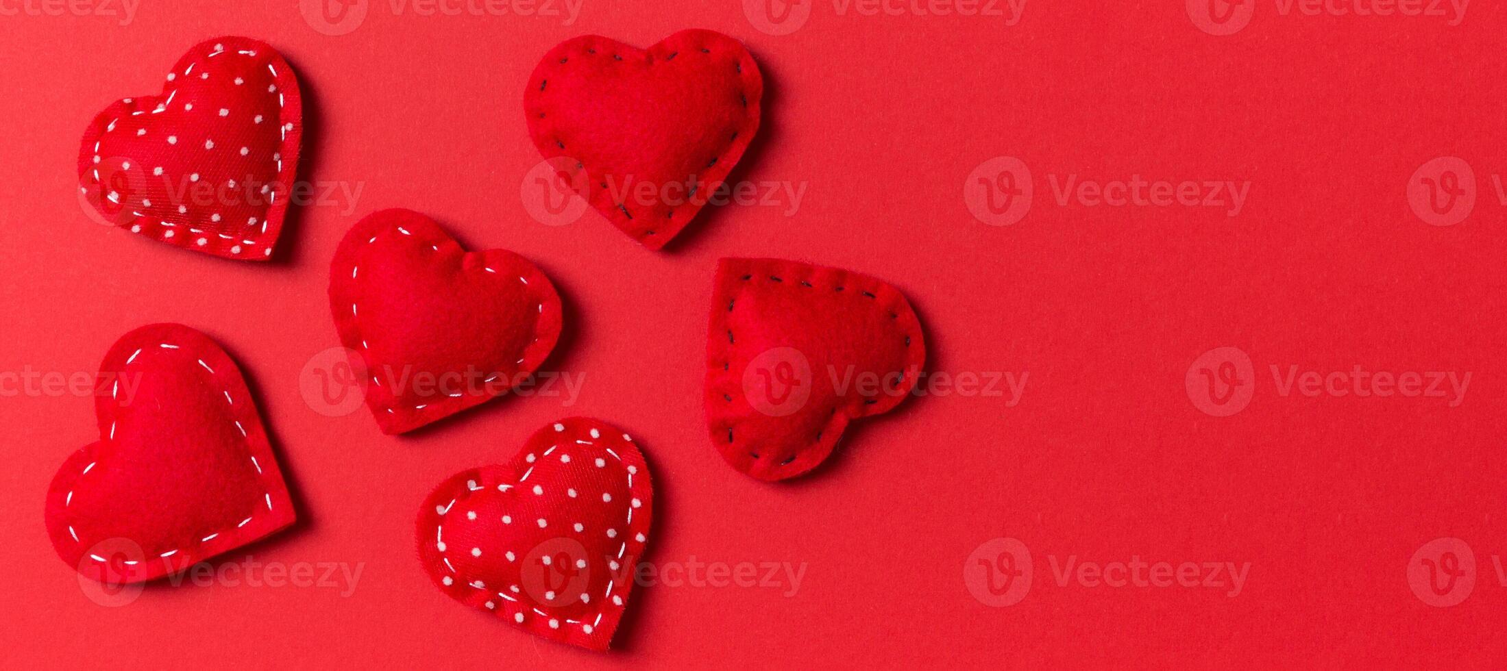 Composition of textile red hearts on colorful background. Close up view. Top view of St. Valentine's day concept photo