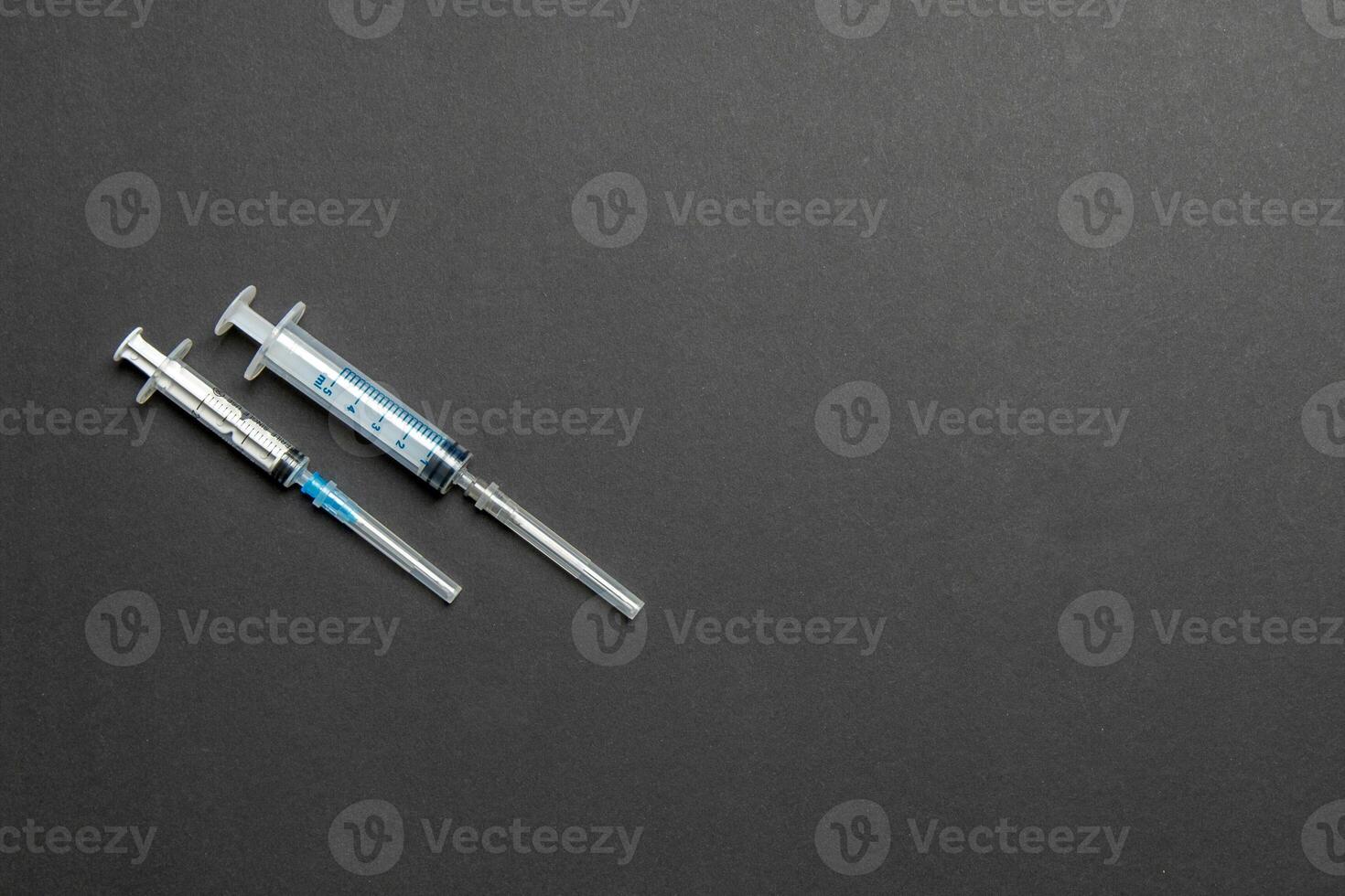 Top view of syringes in a row for medical injection on colorful background with copy space. Health and vaccination concept photo