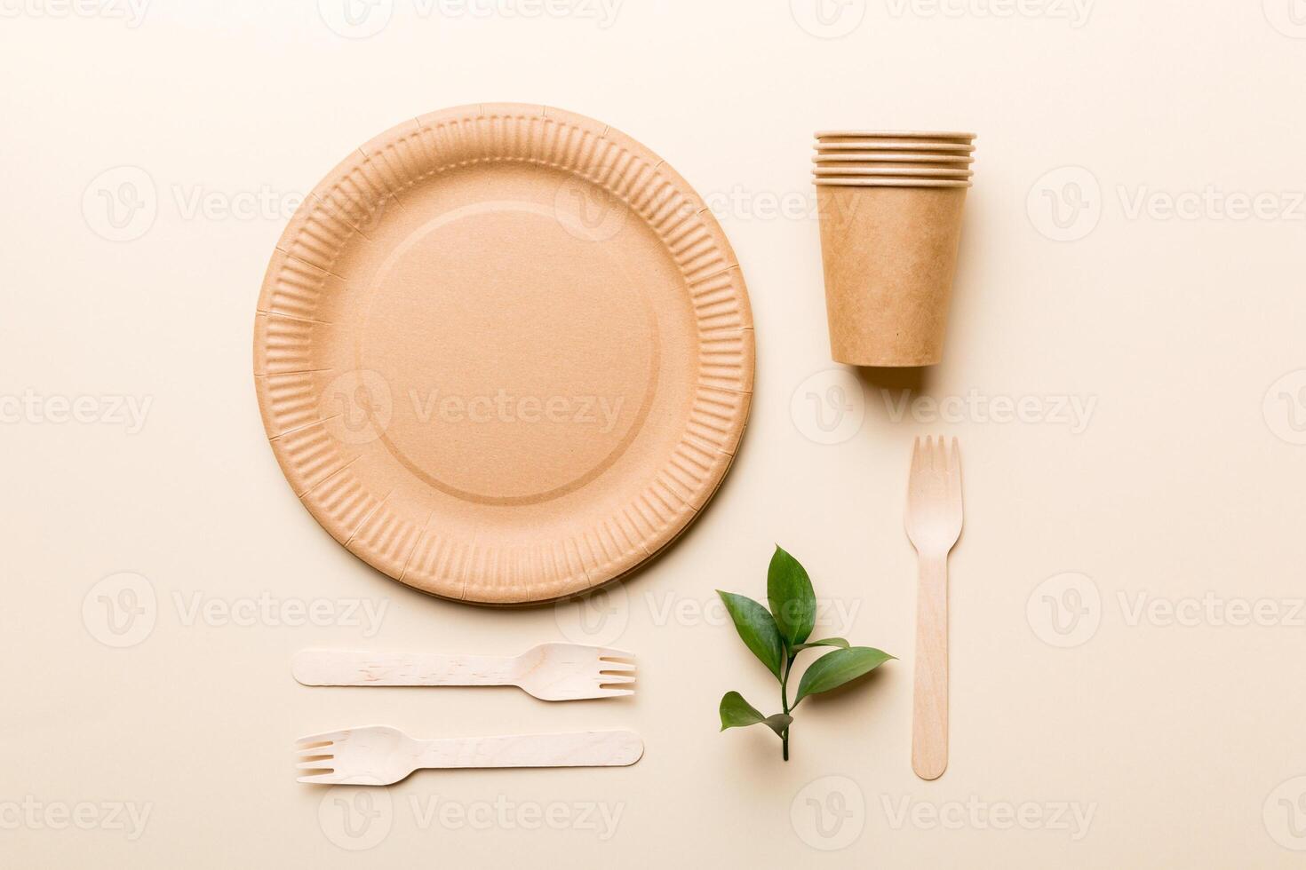 set of empty reusable disposable eco-friendly plates, cups, utensils on light white colored table background. top view. Biodegradable craft dishes. Recycling concept. Close-up photo