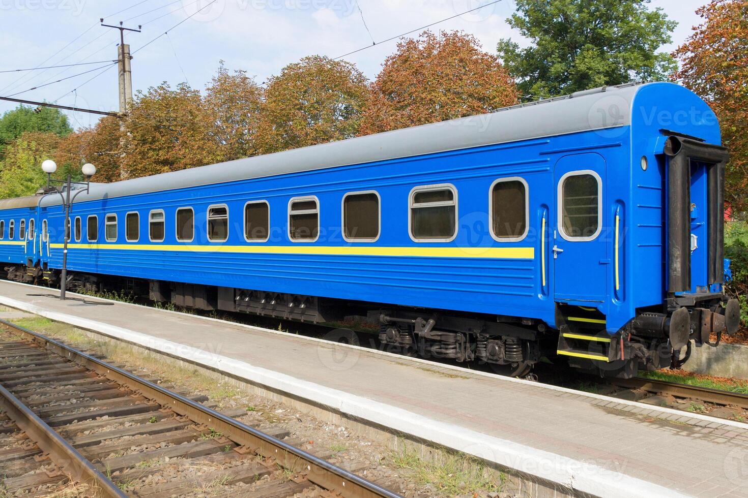 Close up of leaving old blue train at the railway station photo