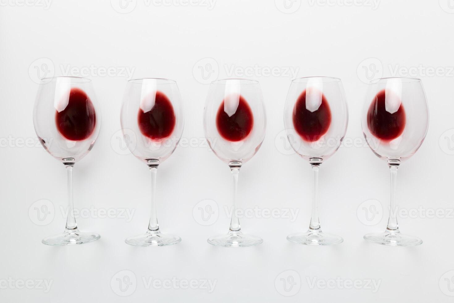 Many glasses of red wine at wine tasting. Concept of red wine on colored background. Top view, flat lay design photo