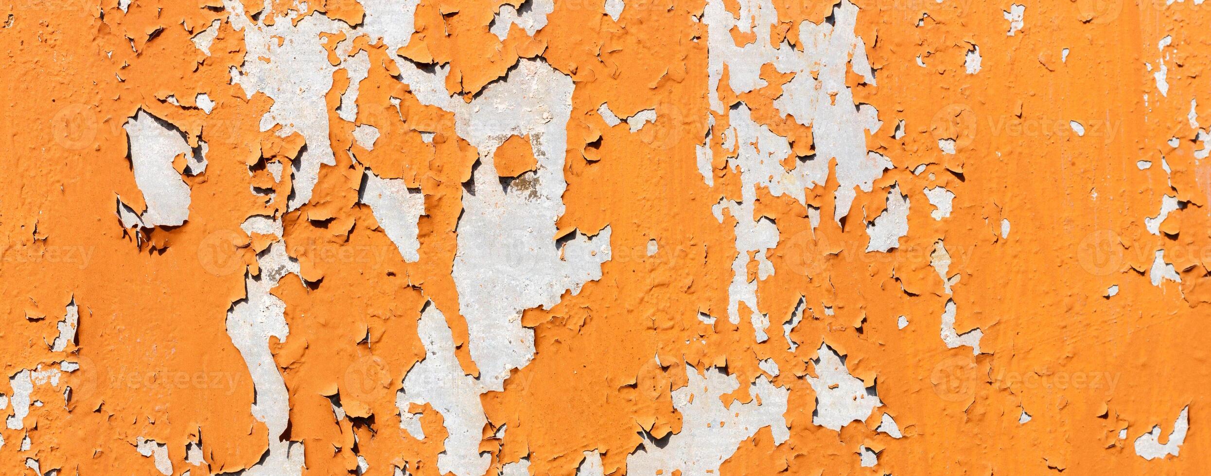 Texture of bright orange paints shabby metal wall photo