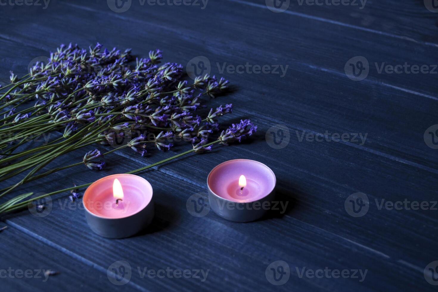 Lavender flowers and wooden love hearts on a dark blue wooden table. Beautiful romantic background with copy space. photo