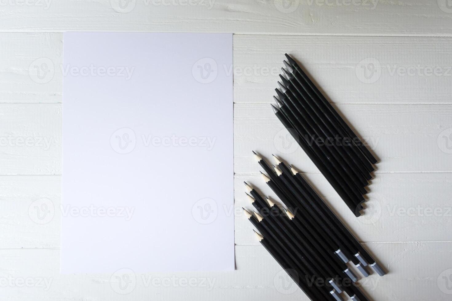 The set of grey pencils on a white background. Tools for drawing on the desk. photo
