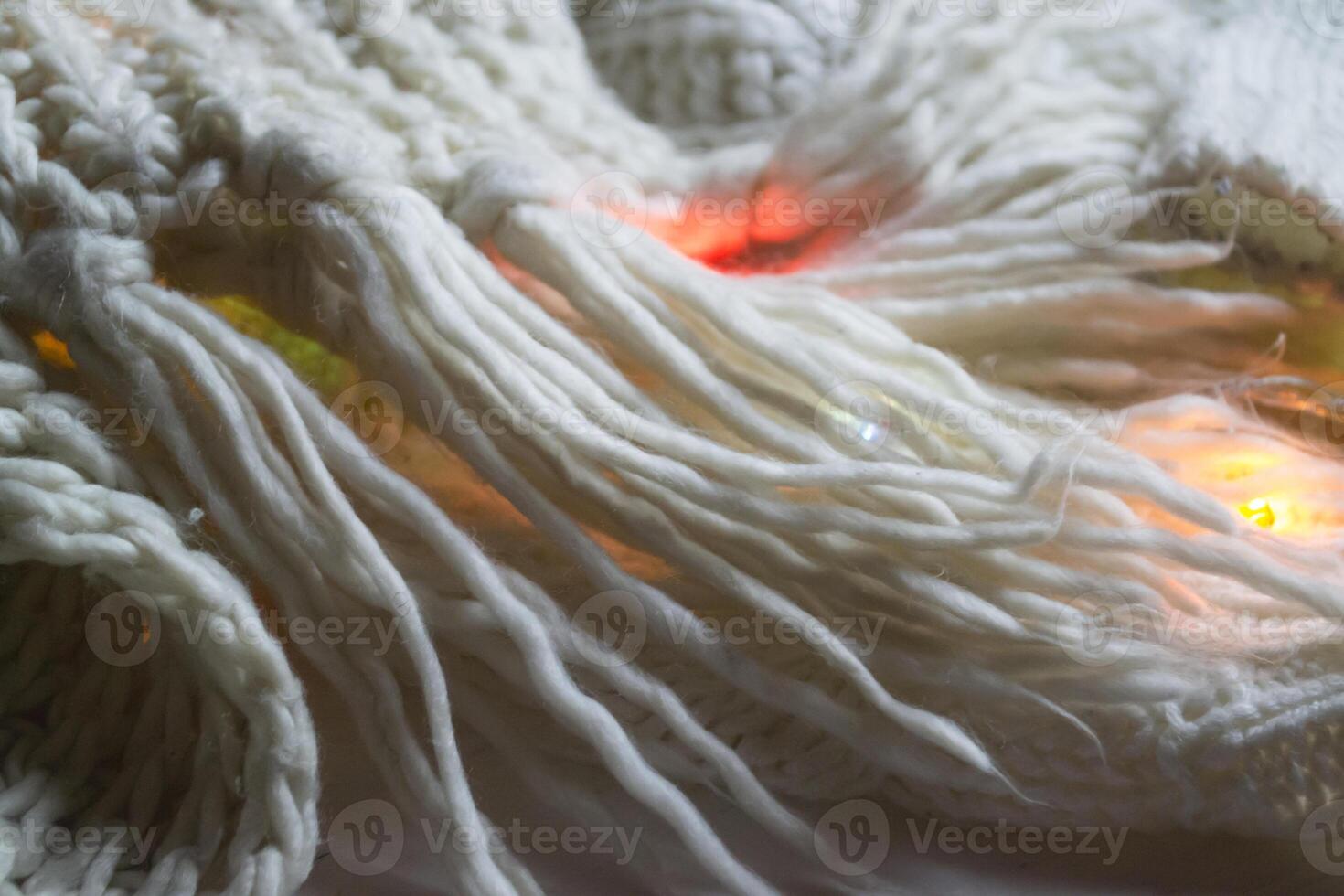 White knitted texture with decor. Soft clothes. Winter season. photo