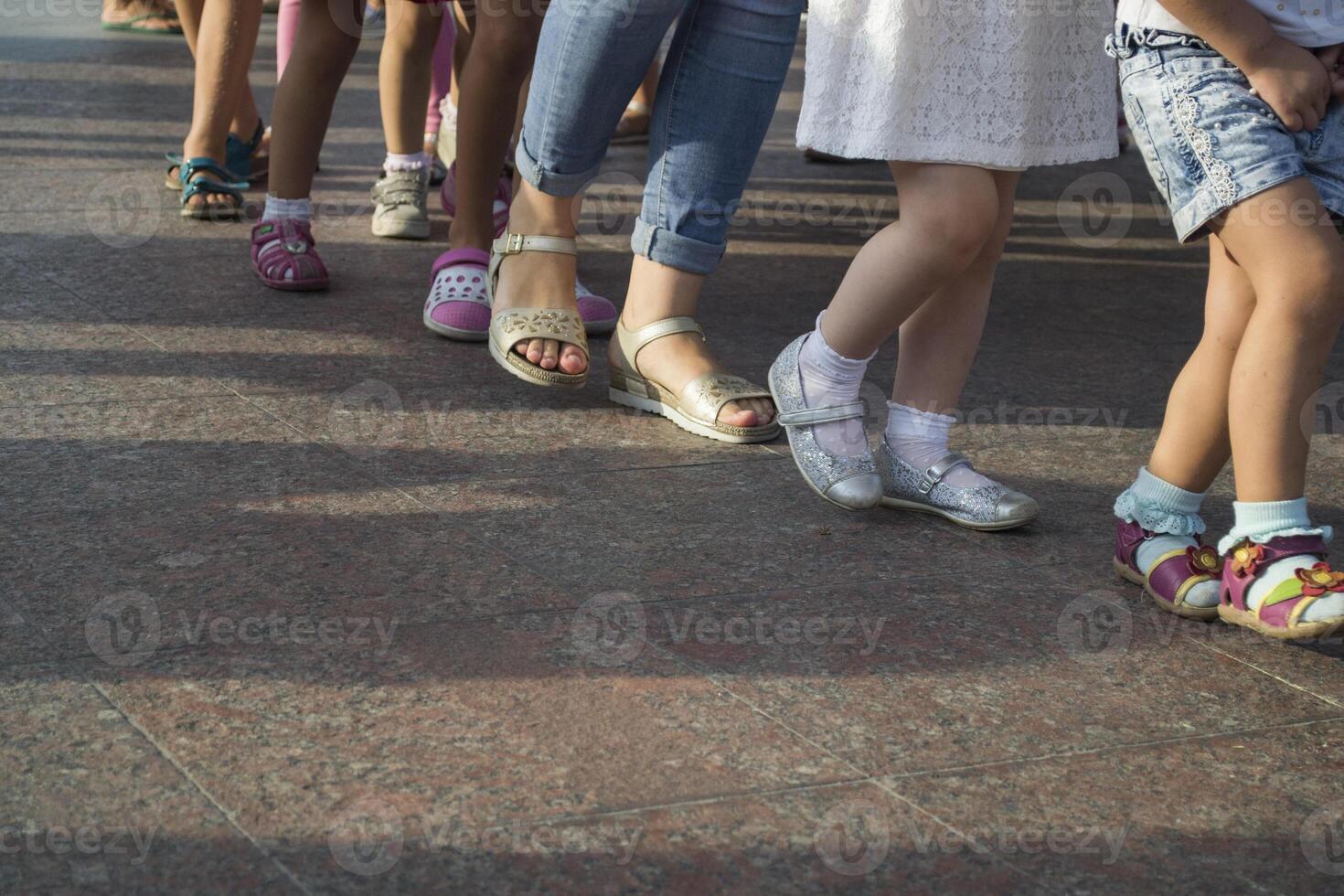 Children's feet one by one. photo