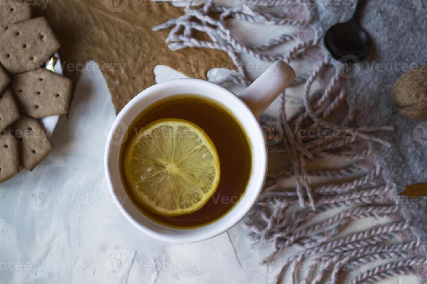 A cup of tea with lemon and cakes. Hygge flat lay. photo