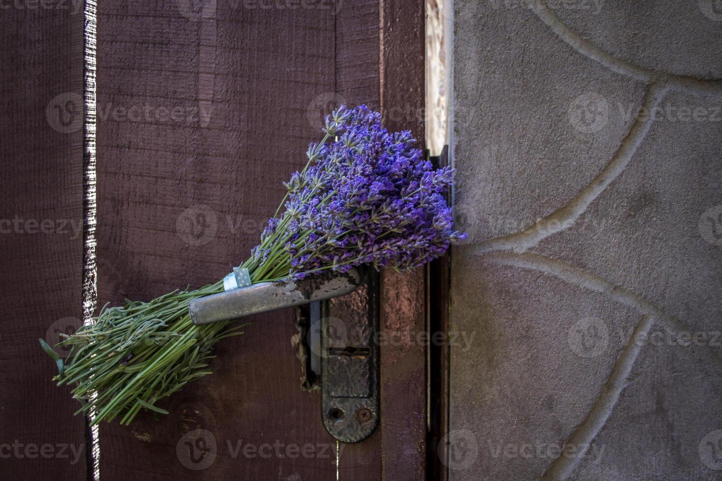 Bouquet of lavender on the lock of vintage door. photo