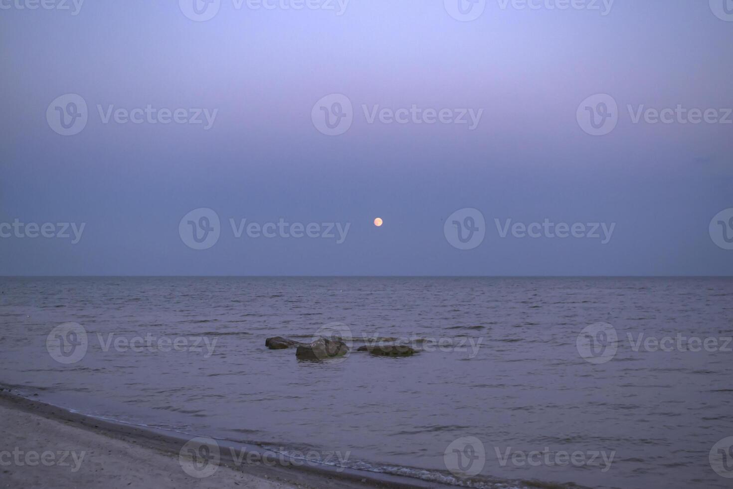 Beautiful sunset on the deserted beach. The place for rest and relaxation. photo