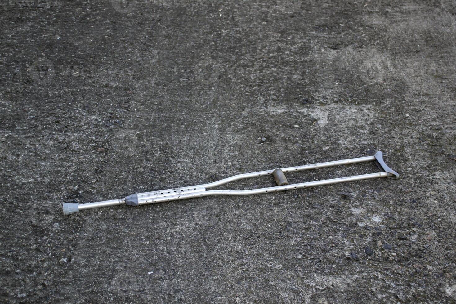 A crutch on asphalt. photo