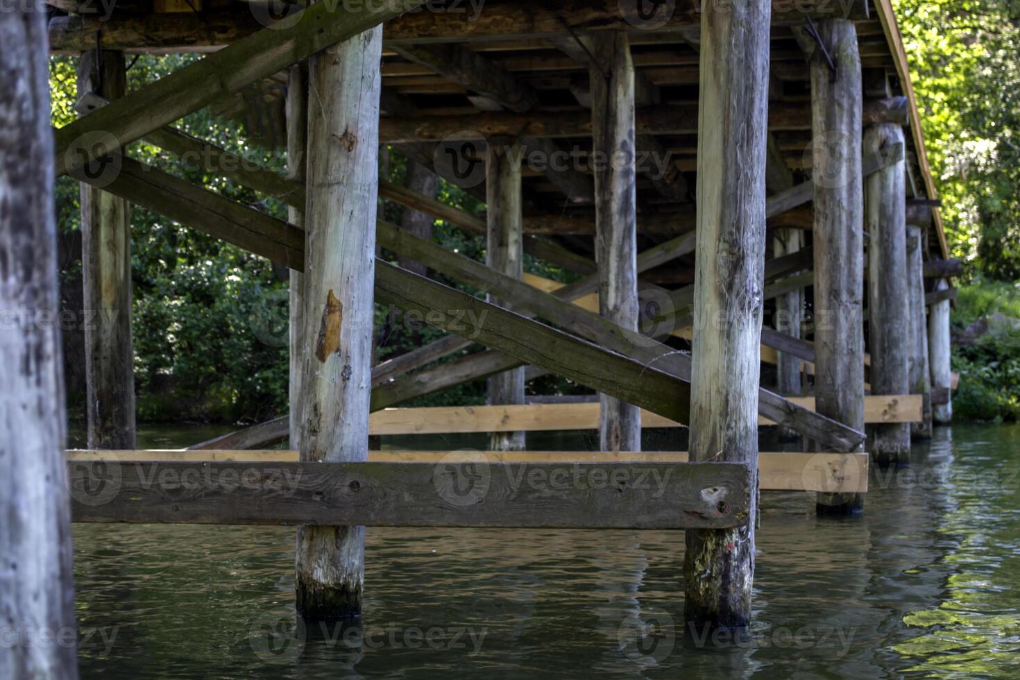 Wooden construction under bridge. Vintage bridge bottom view. photo