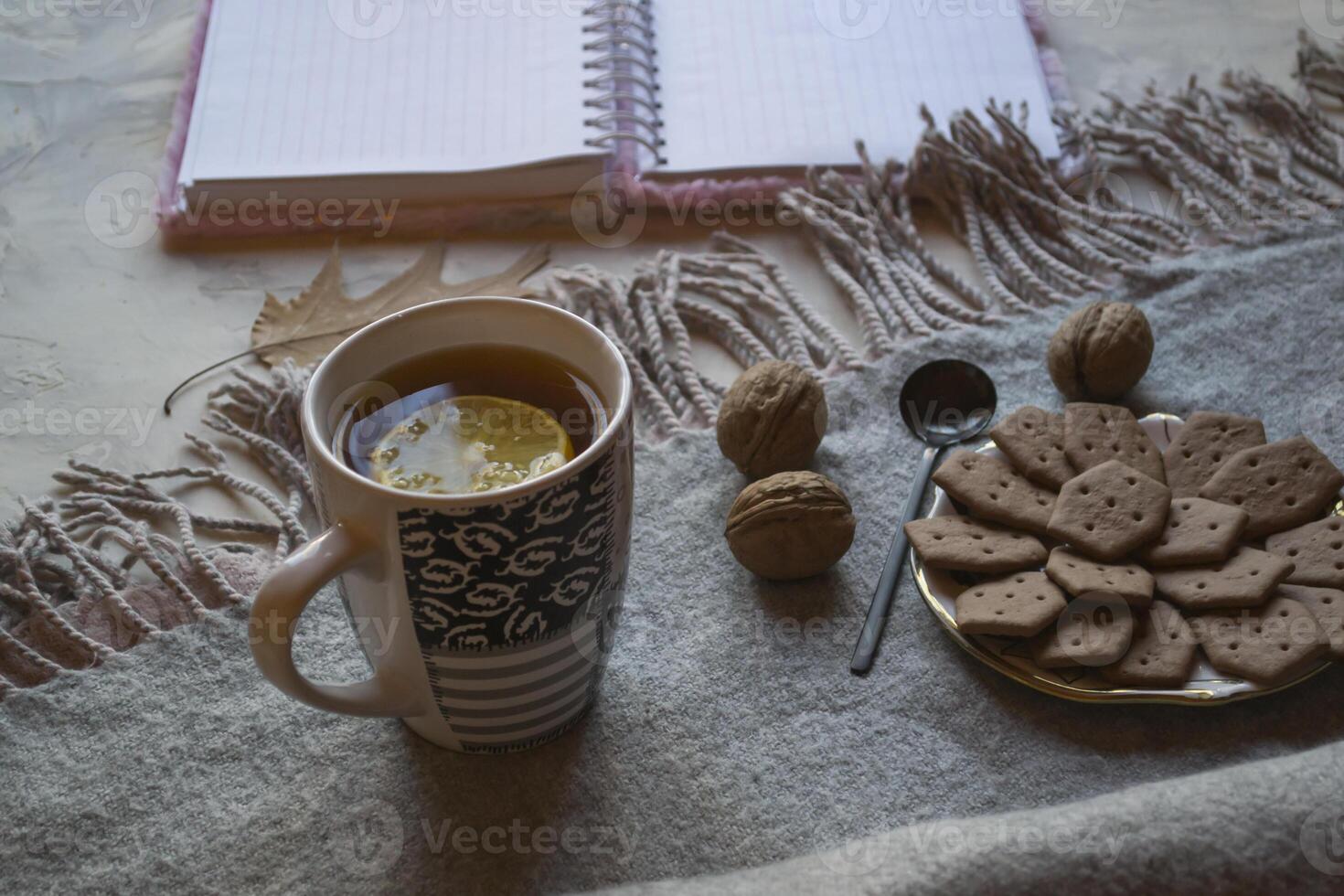 A cup of tea with lemon and cakes. Hygge flat lay. photo