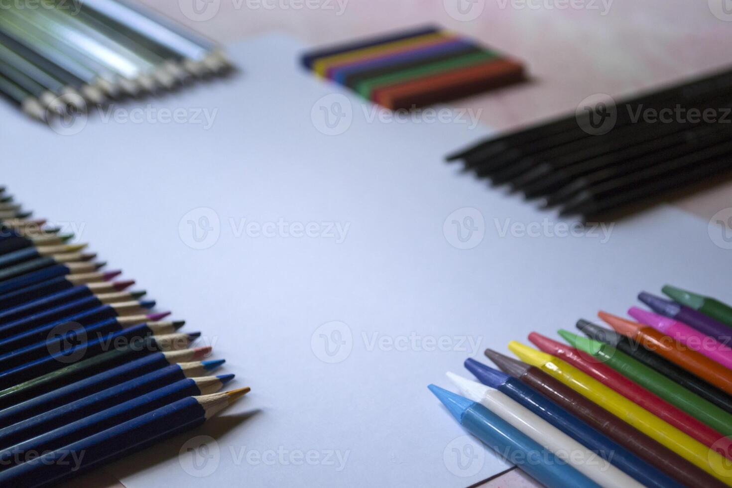 The set of pencils and white paper on the table. photo