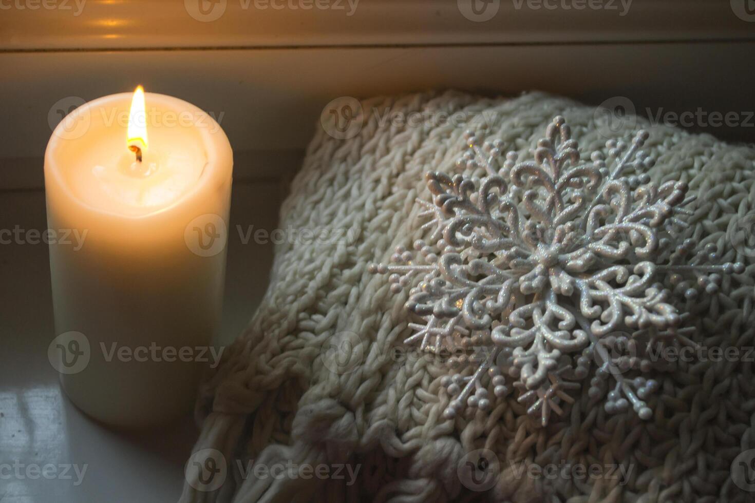 Burning candle and christmas decoration. photo
