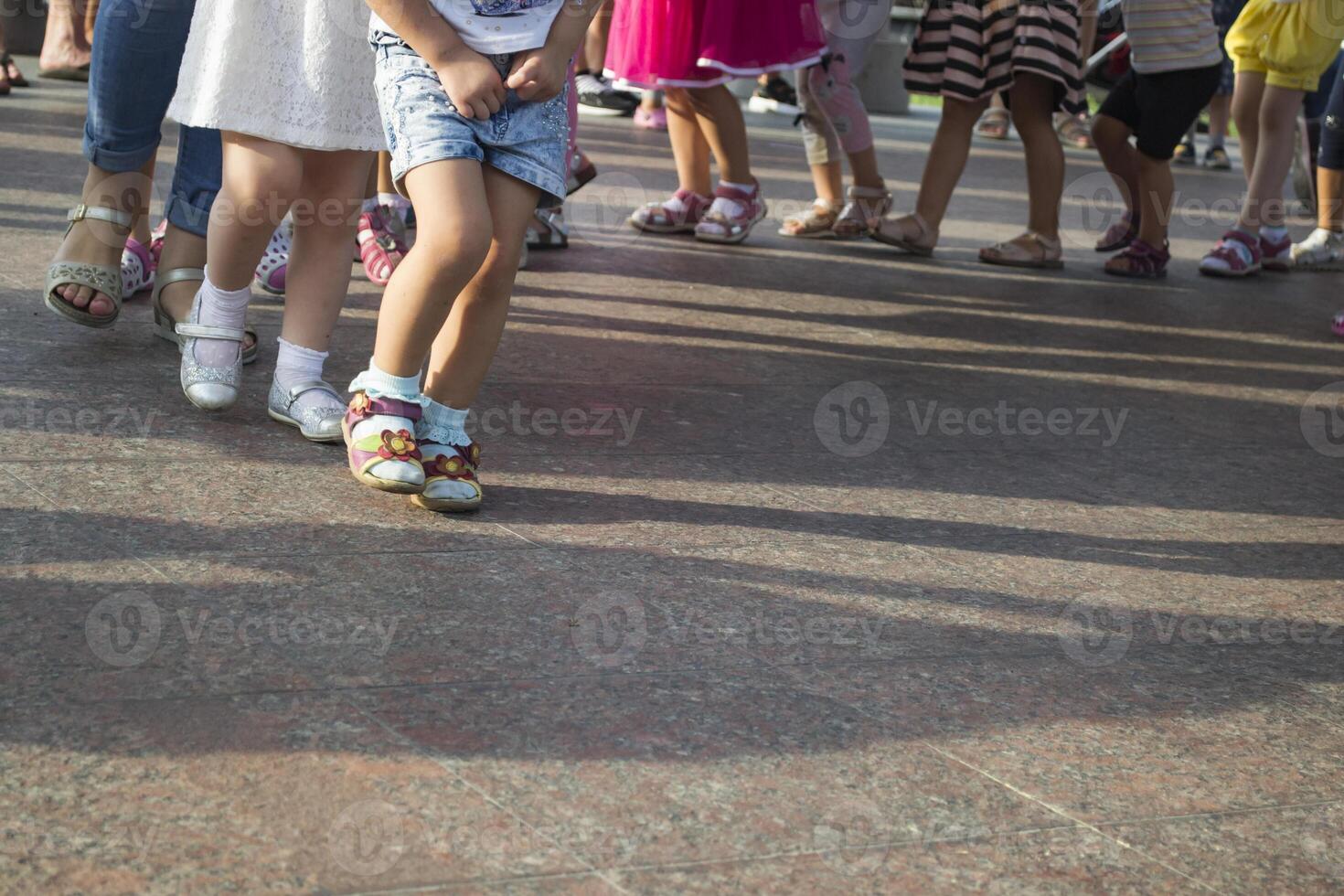 Children's feet one by one. photo