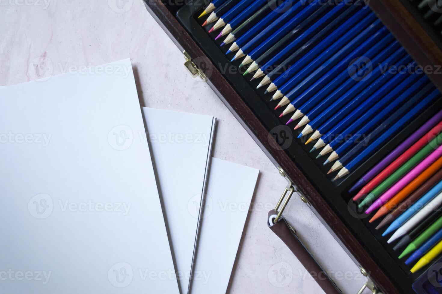 The set of pencils and white paper on the table. photo