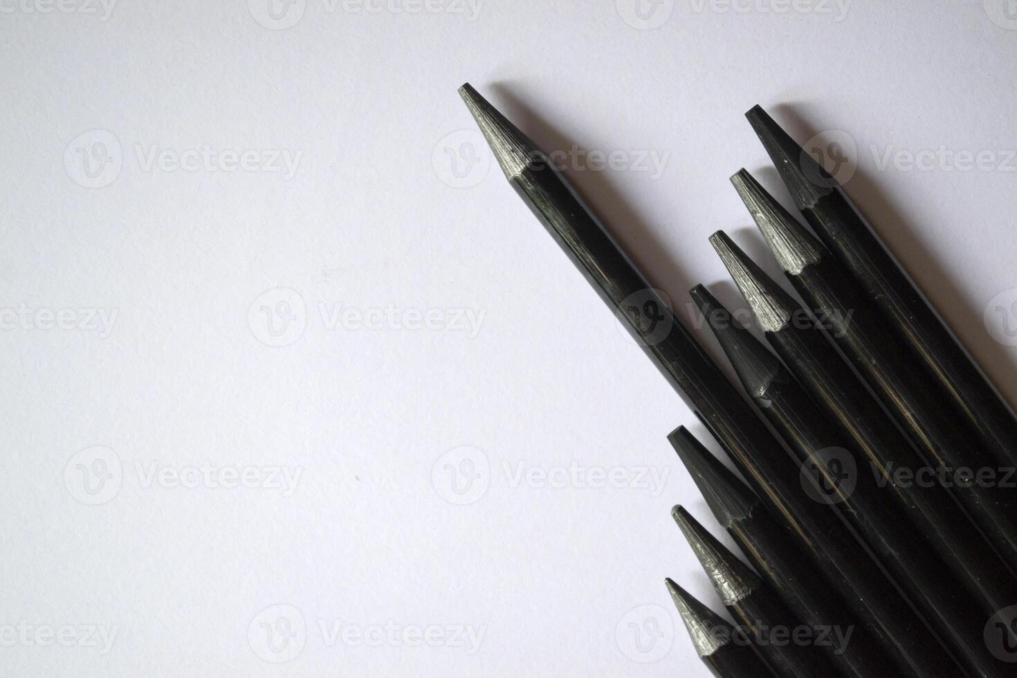 The set of grey pencils on a white background. Tools for drawing on the desk. photo