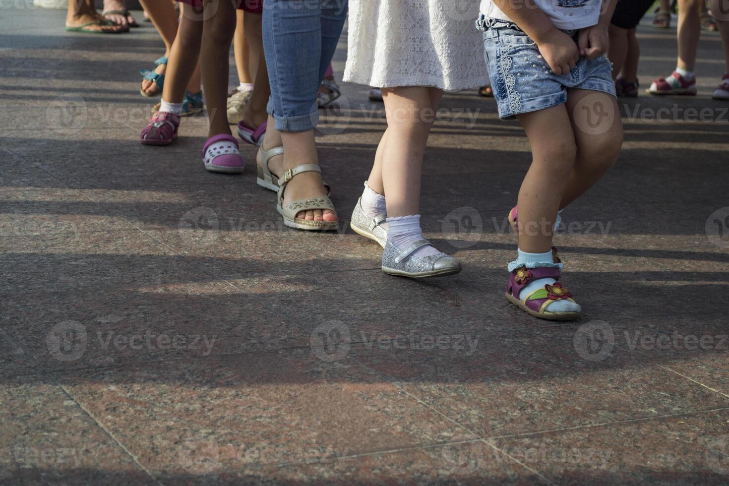 Children's feet one by one. photo