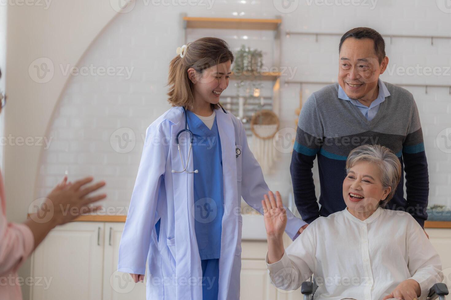 Asian young nurse support couple senior older man and woman in a wheelchair. elderly mature and a group of senior friends living in the hospital. socializing of retired people. photo