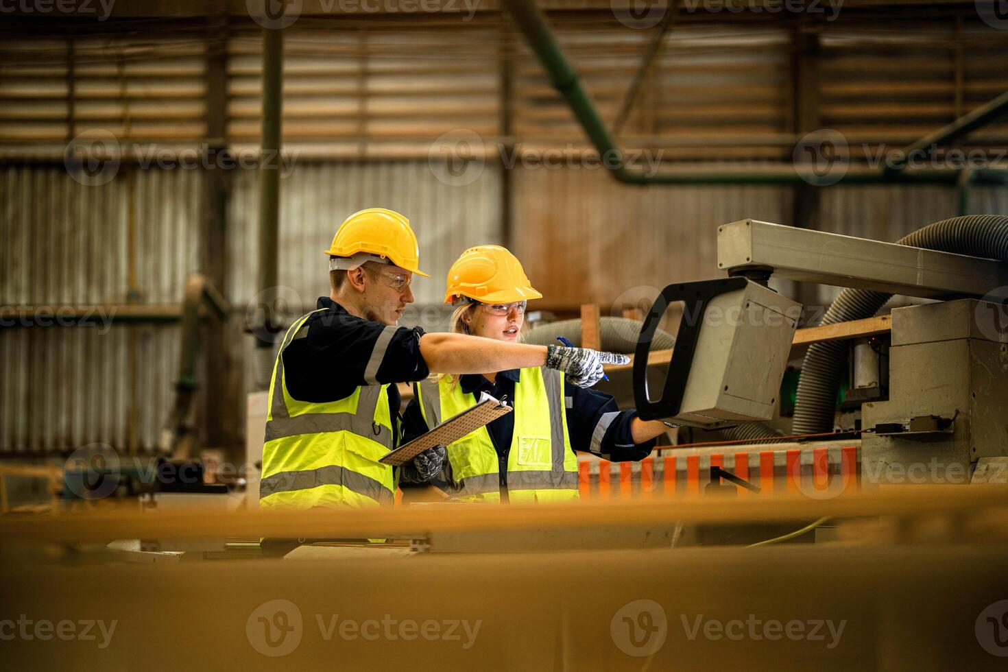 actory engineer workers standing to control panel switch. people works at heavy machine at industry factory. with machinery equipment plant technology. smart industry worker operating. photo