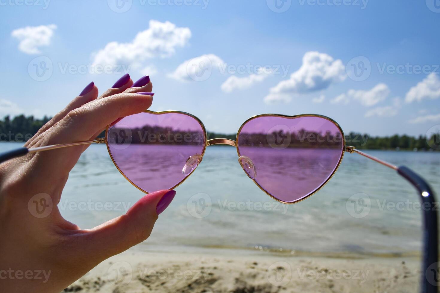 Pink eyeglasses in hand photo