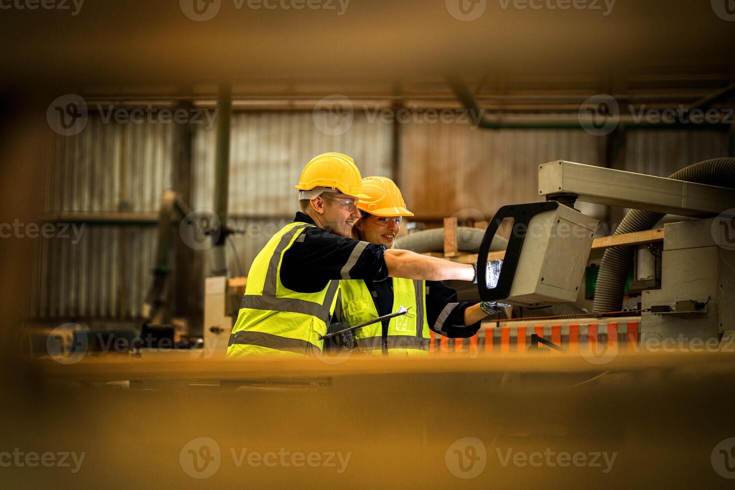 actory engineer workers standing to control panel switch. people works at heavy machine at industry factory. with machinery equipment plant technology. smart industry worker operating. photo